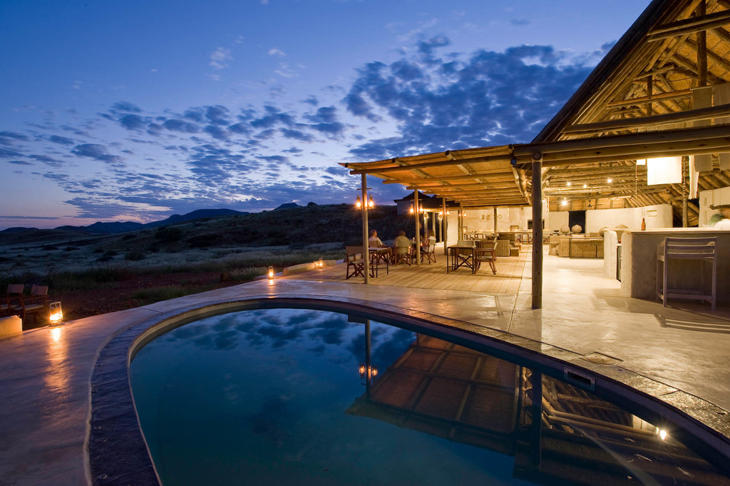 Pool bei Nacht des Damaraland Camp in Namibia | Abendsonne Afrika