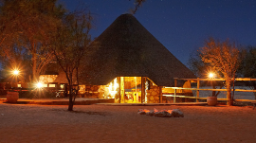 Außenansicht des Kuzikus Camps bei Nacht in der Kalahari in Namibia | Abendsonne Afrika